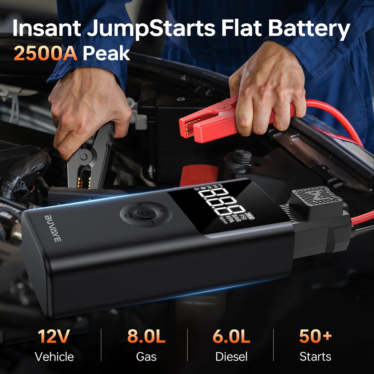 A hand is holding a black portable jump start battery device with red accents, positioned near a vehicle engine bay.