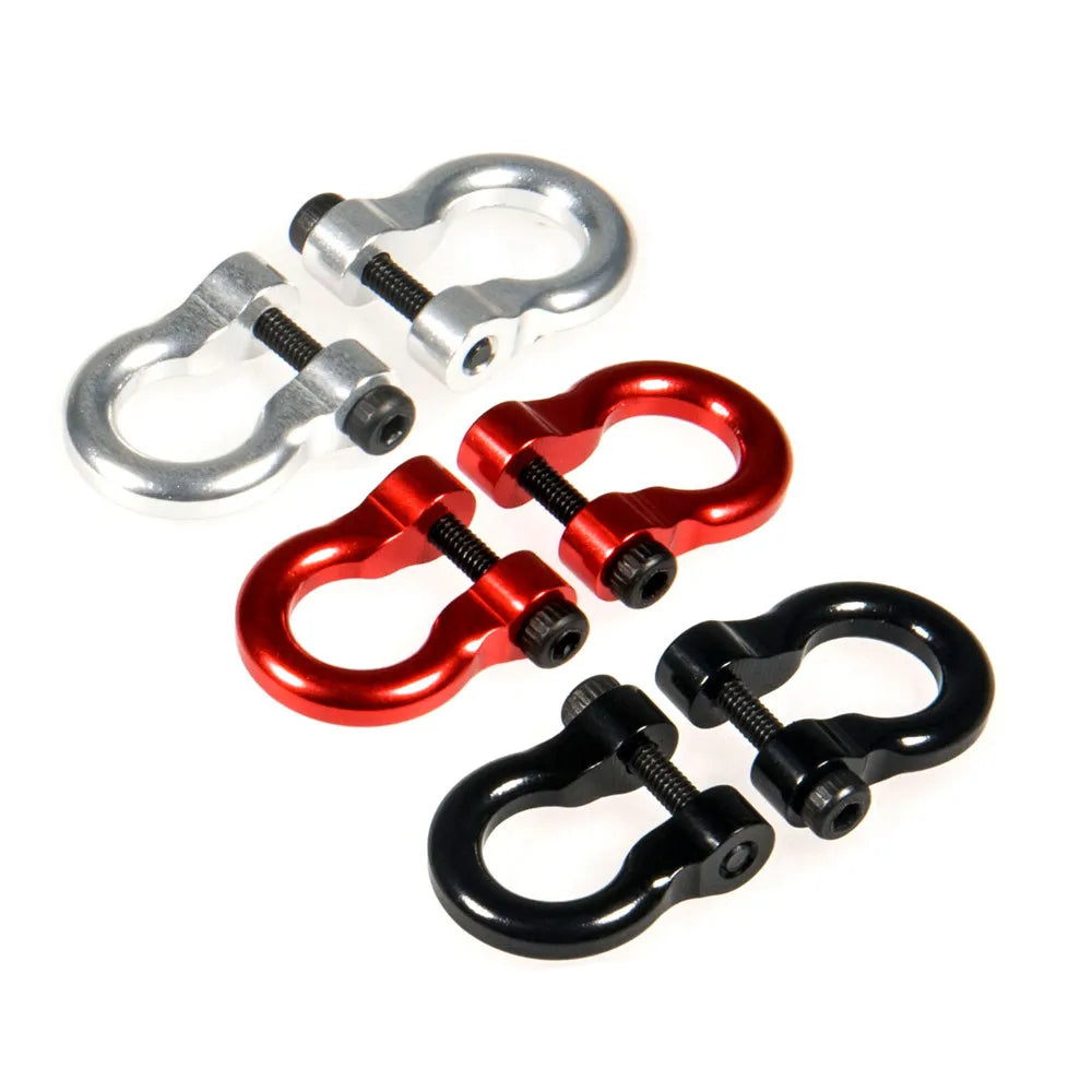 A pair of shiny metal alloy tow shackles for an RC crawler, one silver and one red.