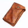 A brown vintage cowhide leather bi-fold wallet with a brass-colored snap closure.