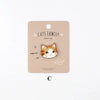 A beige iron-on patch featuring an embroidered orange and white cat face with the text Cats Family and meow.