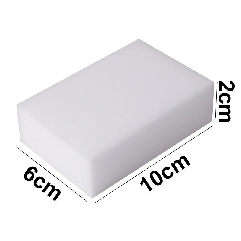 A rectangular white melamine cleaning sponge with dimensions 6cm by 10cm and a thickness of 2cm.