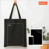 A black canvas tote bag with an A4 sized square printed on it, displayed next to a tablet and smartphone.