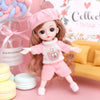 A pink and white fashion doll with long brown hair wearing a pink outfit and hat, displayed on a pink background.