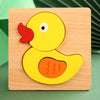 A wooden puzzle featuring a yellow duck with an orange beak and body, set in a light wood square.