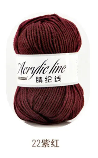 A ball of deep maroon acrylic line yarn labeled as 22-gauge in a white band.