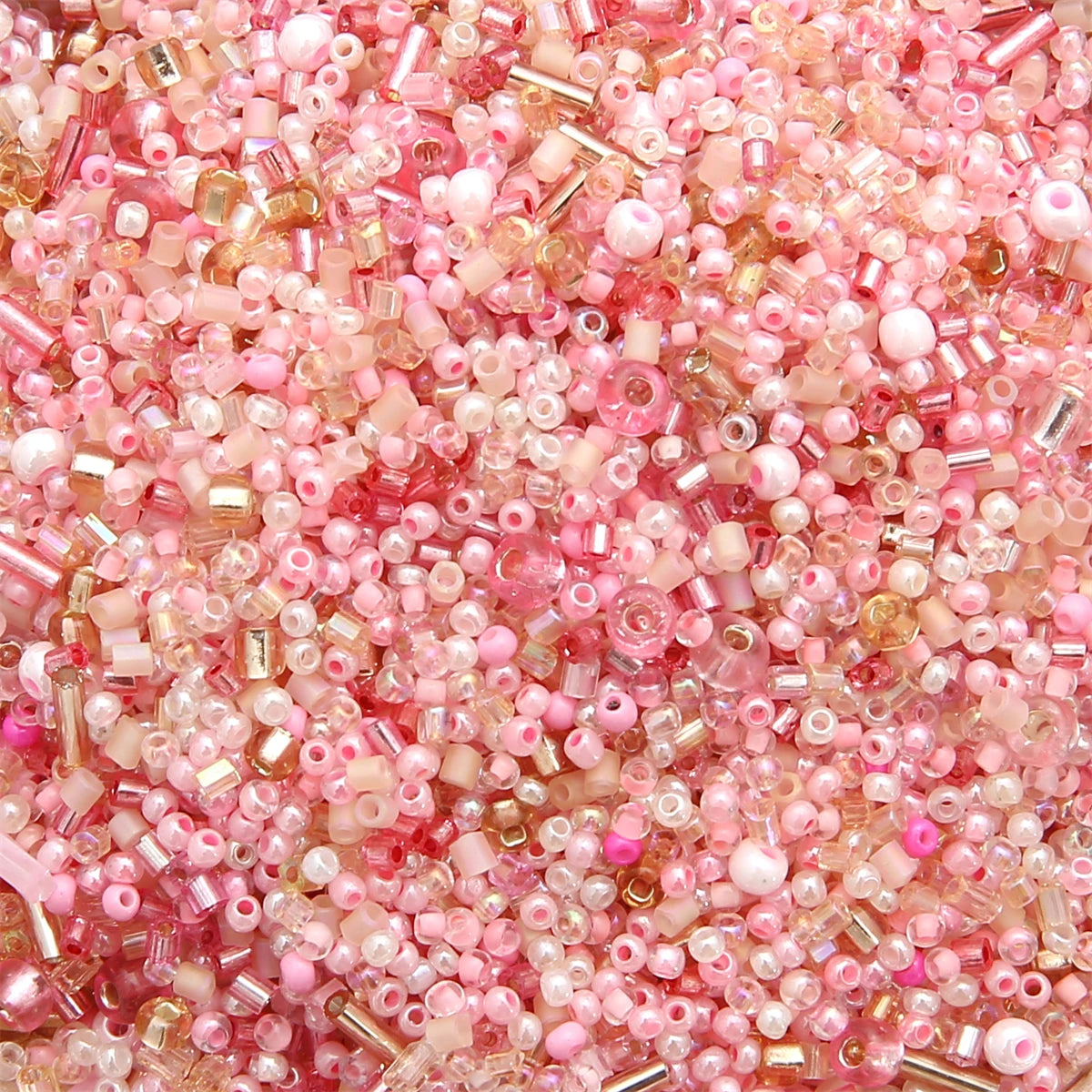 A close-up view of mixed pink and rose glass seed beads for jewelry making and crafts.