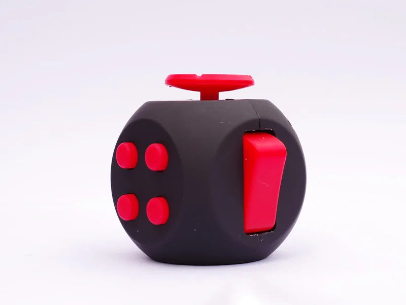 A black fidget cube with red buttons is shown against a white background.