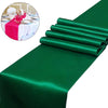Emerald green satin table runner rolled neatly for weddings and events