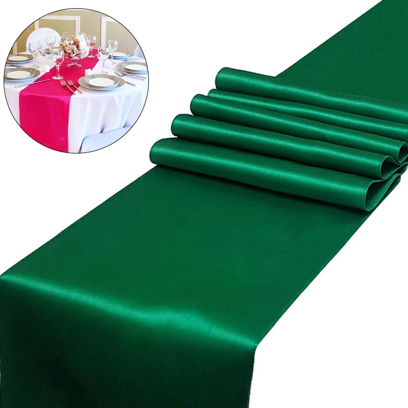 Emerald green satin table runner rolled neatly for weddings and events