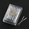 A clear plastic box containing a multi-pack of sewing machine needles with gold markings on the packaging.