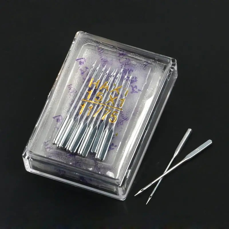 A clear plastic box containing a multi-pack of sewing machine needles with gold markings on the packaging.