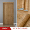 A wooden door featuring a vertical grain pattern, shown alongside rolls of wood grain wallpaper.