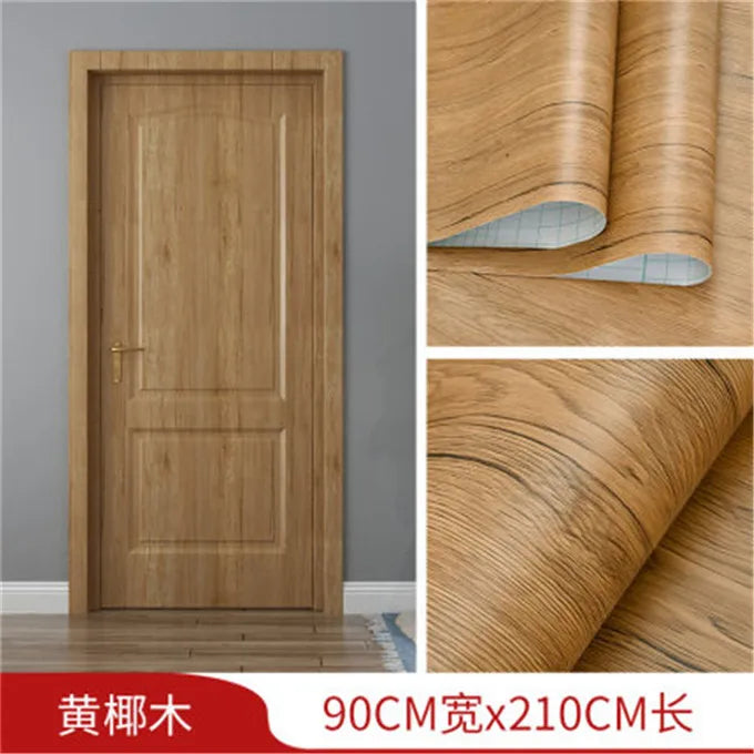 A wooden door featuring a vertical grain pattern, shown alongside rolls of wood grain wallpaper.