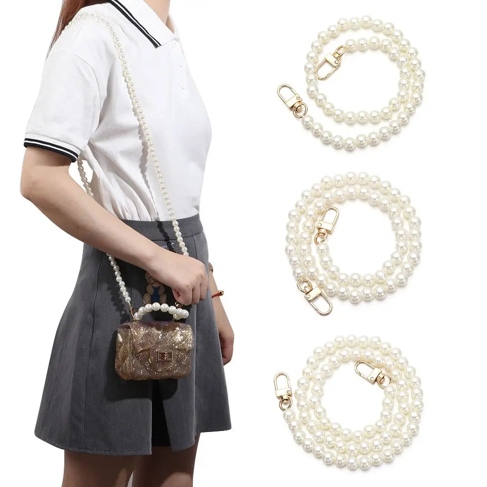 A woman models an elegant pearl chain strap for a handbag, showing the delicate jewelry and its use.