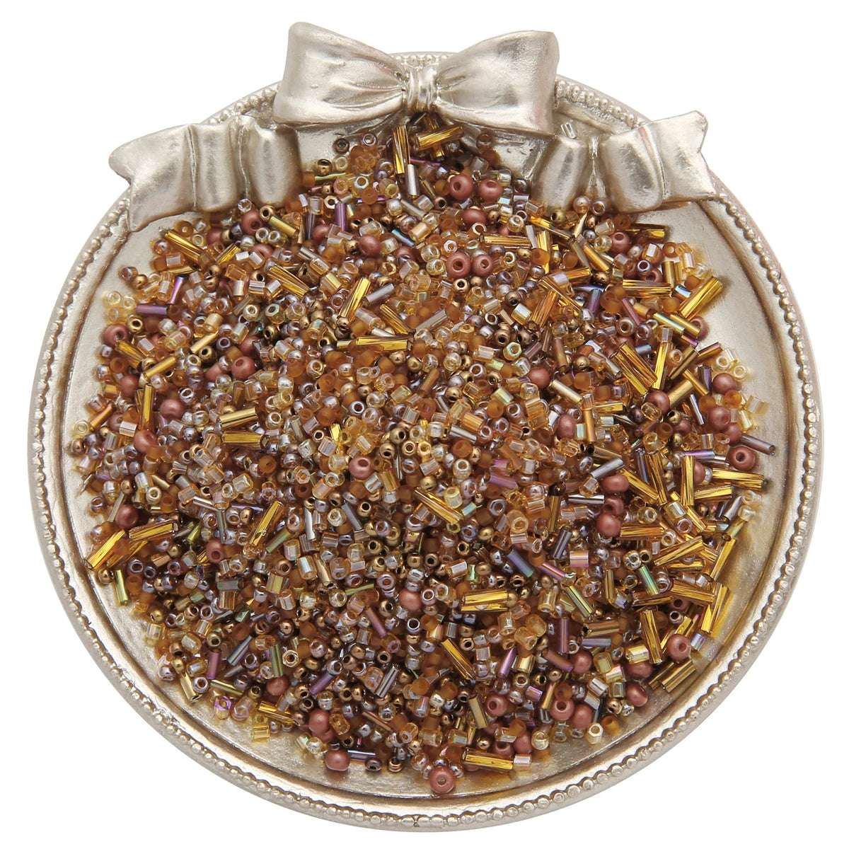 A small, ornate silver dish filled with a pile of mixed glass seed beads in various shades of brown and gold.