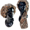 A black mannequin head wearing a double-layer satin hair bonnet with an adjustable band featuring a leopard print fabric.