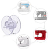 A collection of sewing machines, including white, gray, and red models, with transparent plastic bobbins shown in various ang