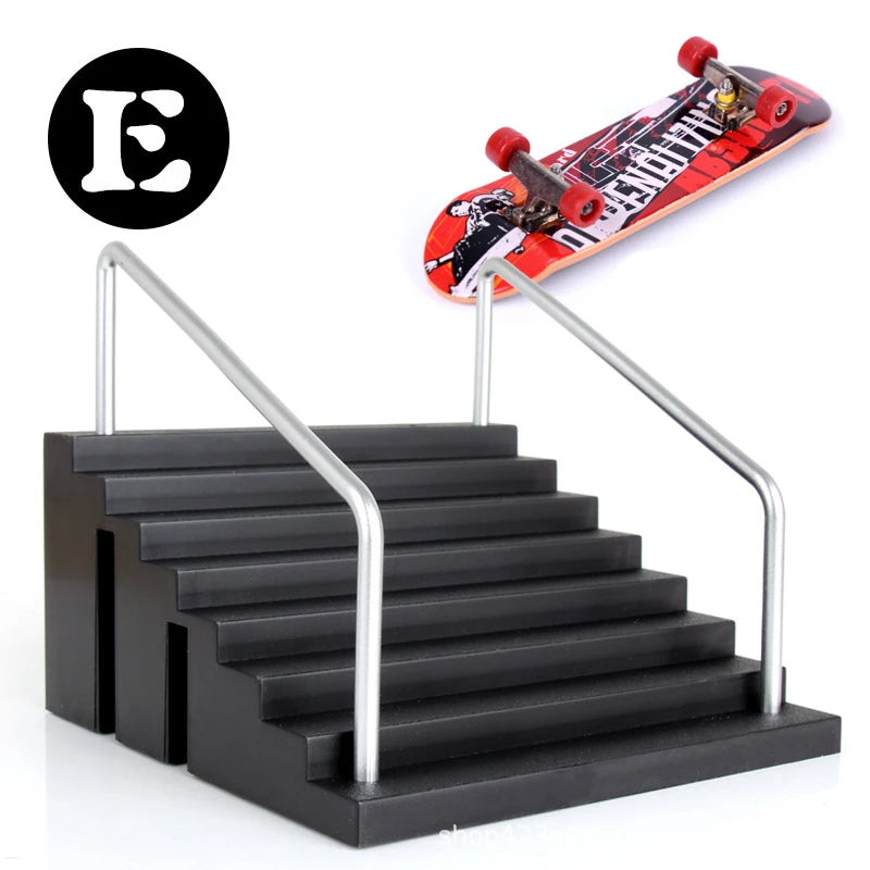 A finger skateboard set with a park ramp is shown next to a black metal staircase.