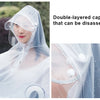 Double-layered transparent waterproof motorcycle rain poncho with a hood being worn.