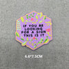 A pink and purple embroidered iron-on patch with a hexagonal shape featuring green and pink floral designs.