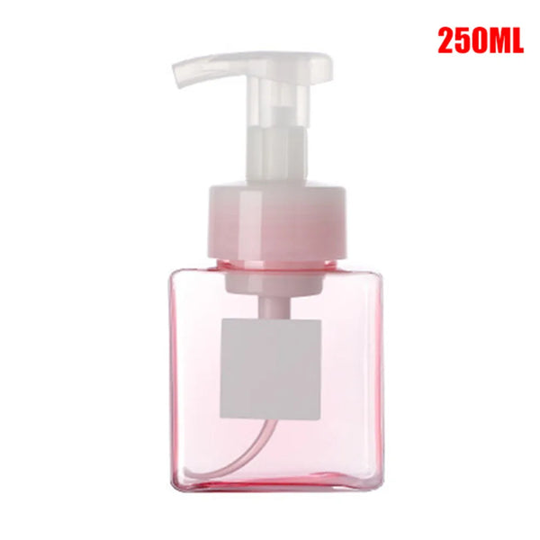 A clear pink portable manual foam soap dispenser bottle with a pump top.