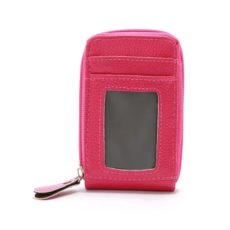 A pink genuine leather RFID-blocking card holder wallet with a clear window.