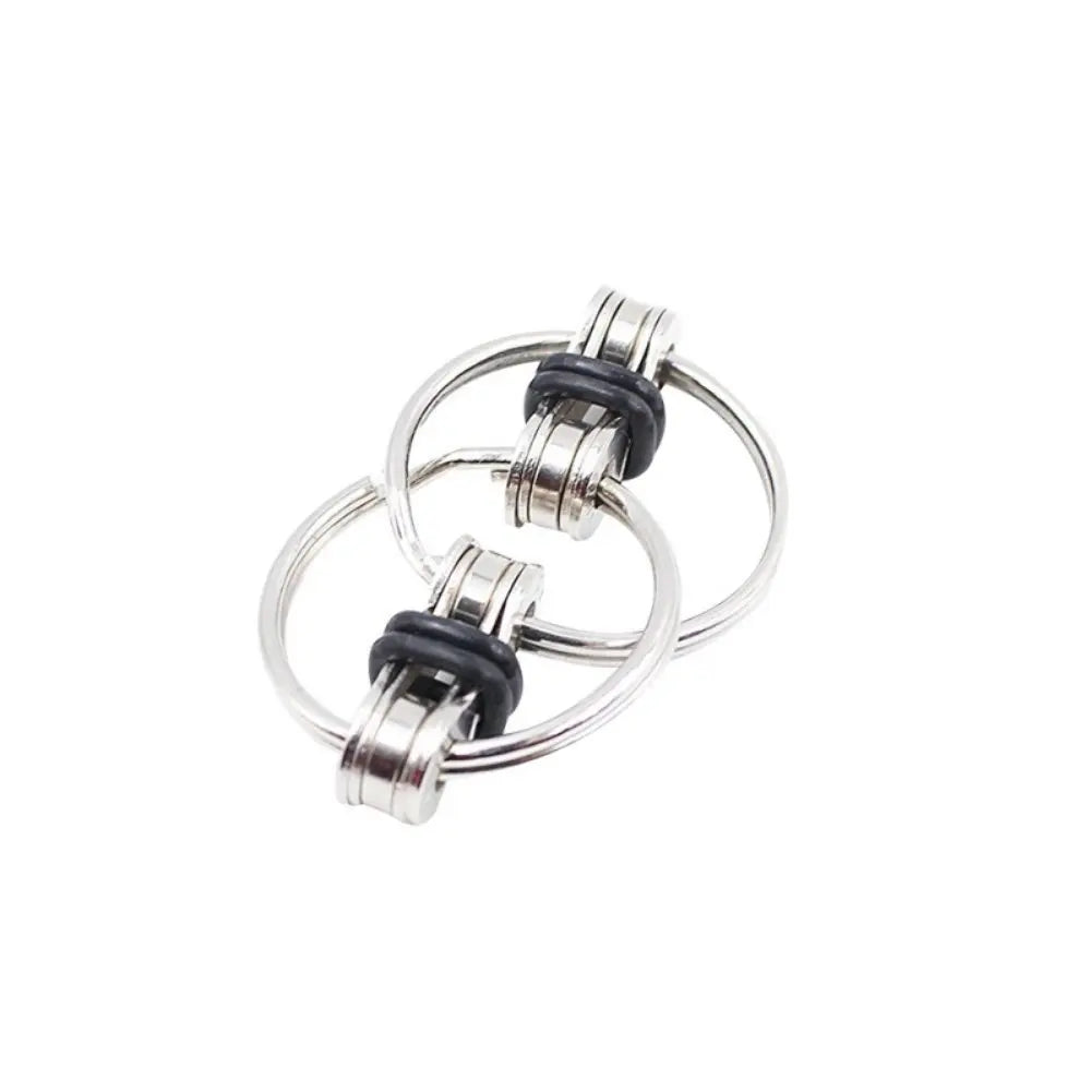 A silver 12-sided fidget cube with black accents shown from above.