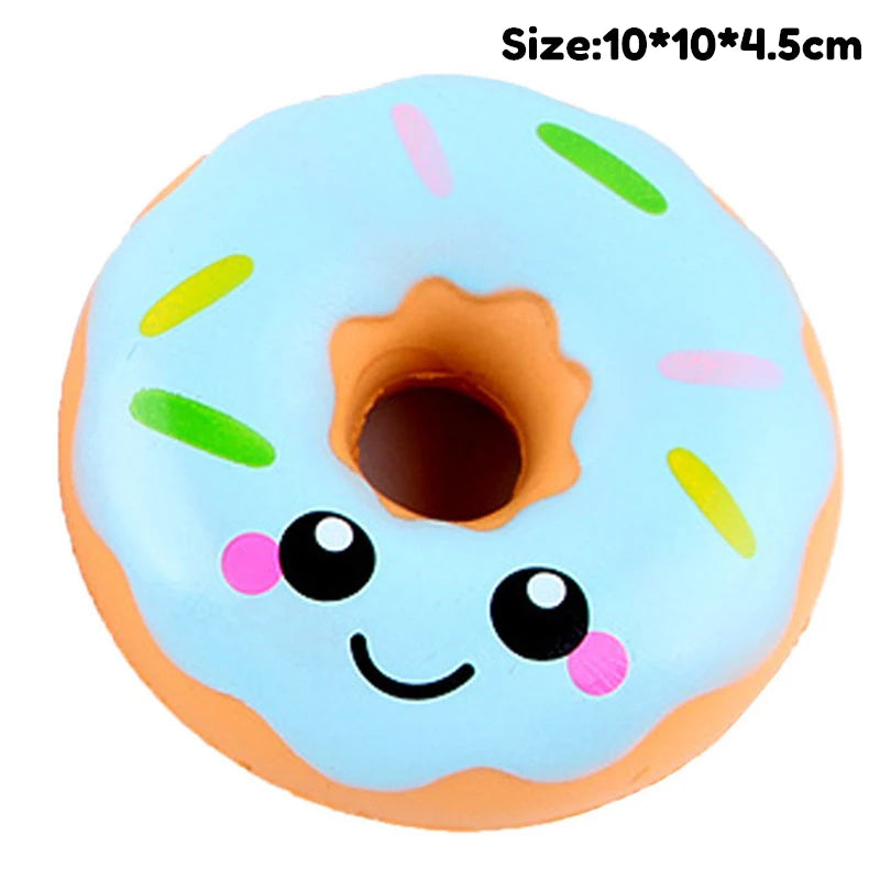 A light blue squishy toy shaped like a face with pink and green accents.