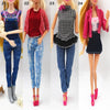 Four fashion dolls wearing different styles of denim and casual clothing outfits