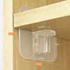 A set of adhesive shelf support pegs is shown mounted on a wooden panel with dimension lines indicating placement.