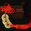 Chinese Feng Shui wealth coins with gold coins tied together with a red handmade knot