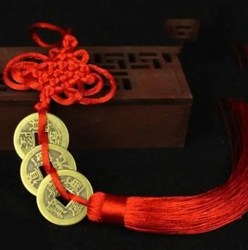 Chinese Feng Shui wealth coins with gold coins tied together with a red handmade knot