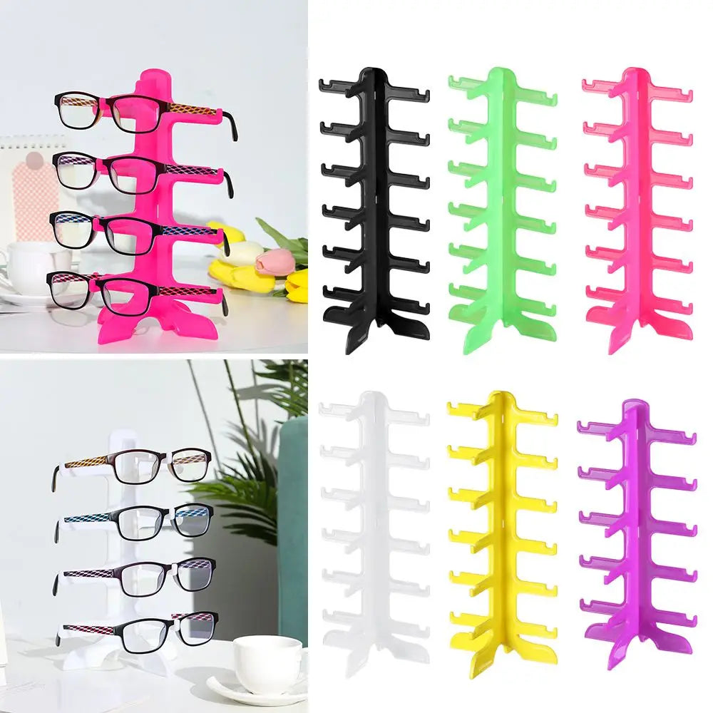 A collection of stackable eyeglass display stands in various colors including pink, green, black, and yellow.