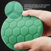A hand holds a green hexagonal foam buffing pad, highlighting its high quality and durability.