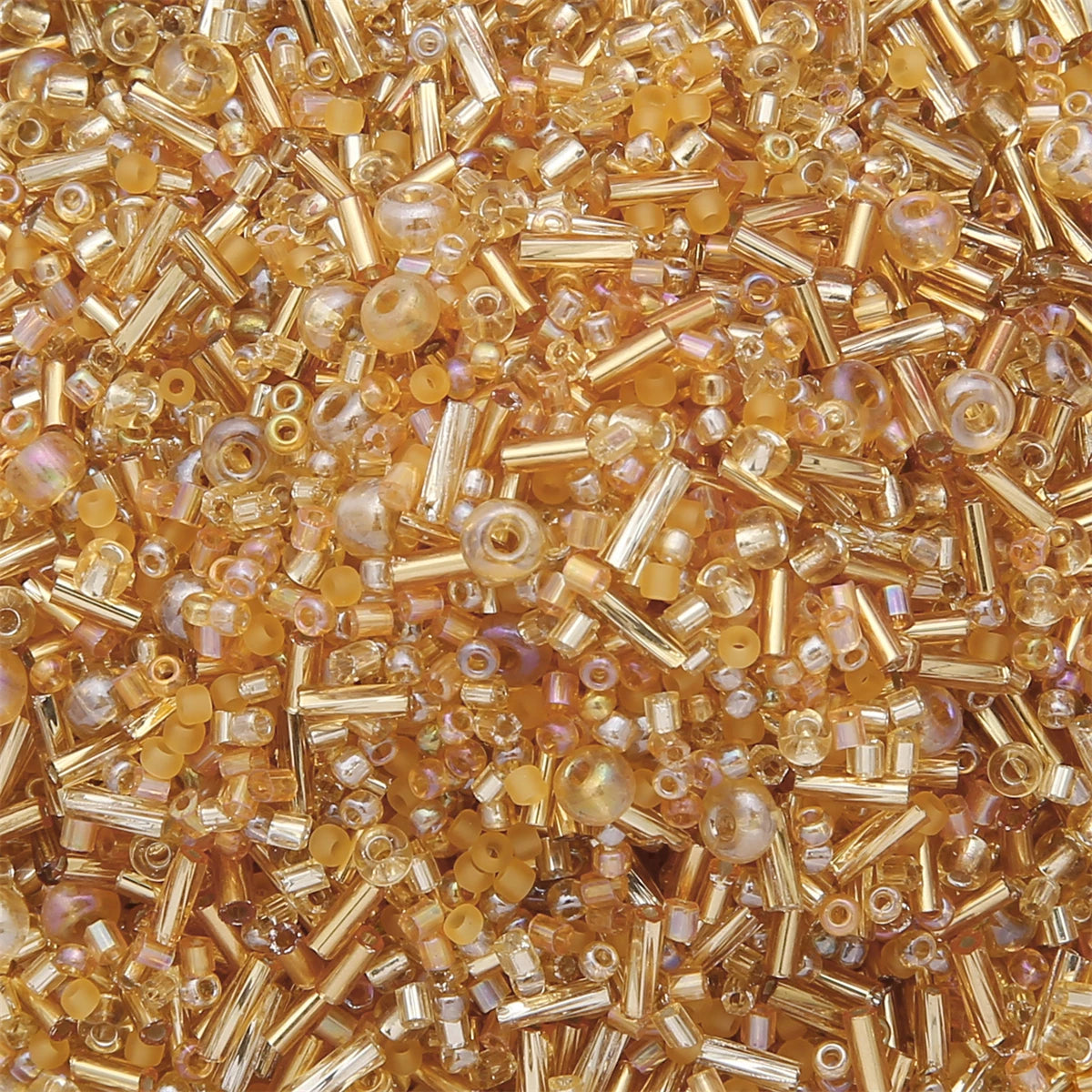 Close-up of mixed amber and clear glass seed beads for jewelry making and crafts