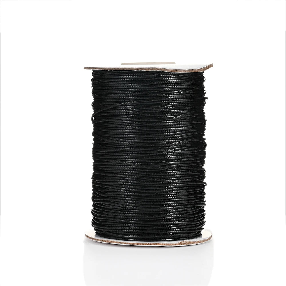 A spool of black waxed cotton cord for jewelry making