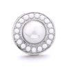 Silver snap button with a central white oval surrounded by a border of smaller white buttons
