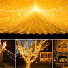 A ceiling draped with warm yellow string lights creating a festive glow.