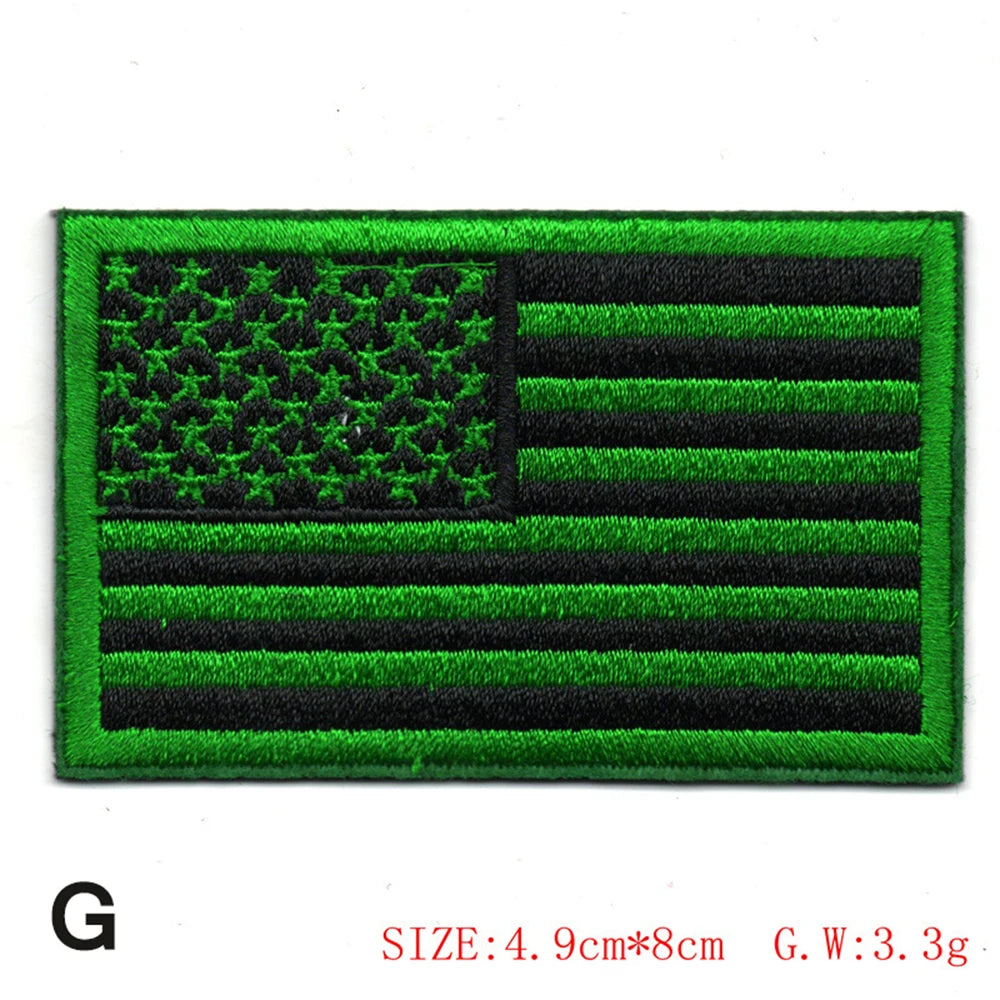 Embroidered American flag patch featuring green and black stripes and stars.