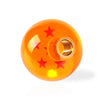 An orange spherical gear shift knob with a star design and a metallic cap.