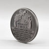 Antique silver plated commemorative coin featuring a patriotic two-gun design and text