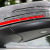 Close-up of a car's exterior featuring reflective vinyl mirror decals on the hood and bumper.
