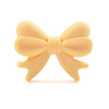 A light peach silicone bow or crown bead used for jewelry making and DIY crafts.