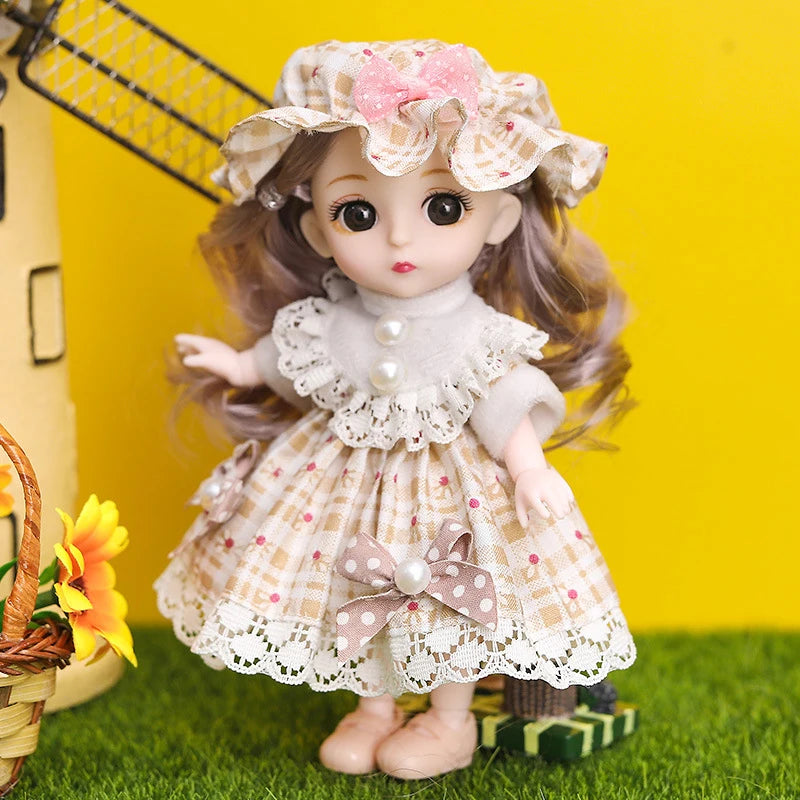 A light-skinned fashion doll with long brown hair wearing a floral hat and a white lace dress on green grass.