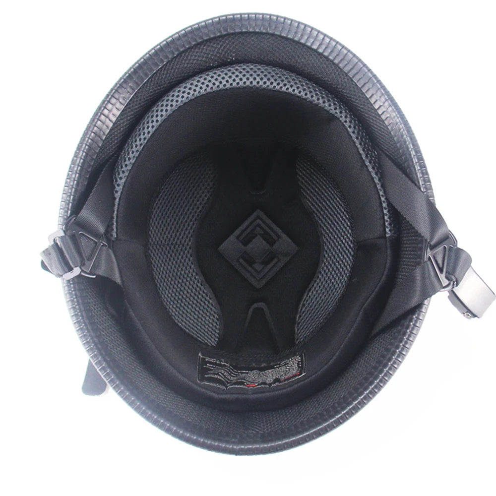 Matte black vintage German half-face motorcycle helmet with a textured interior and strap visible from above.