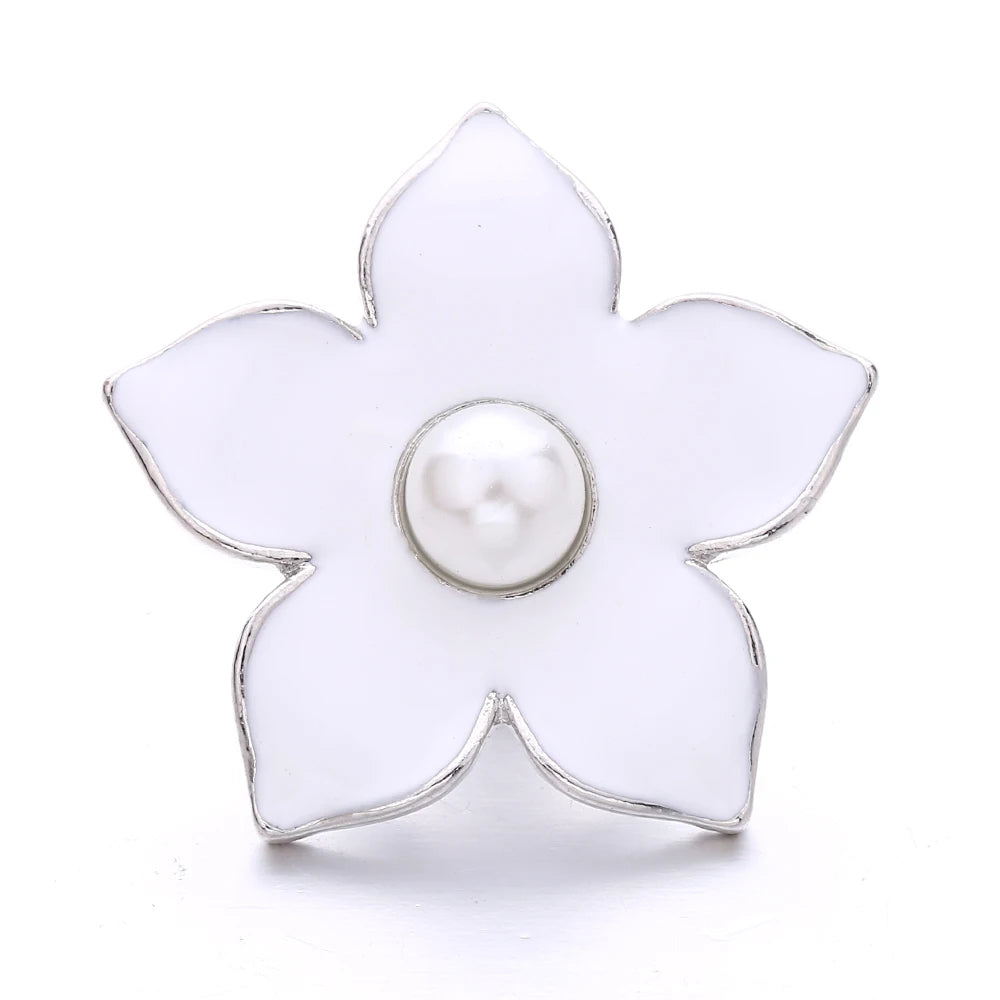 A white flower shaped metal snap button with a pearl center for jewelry making