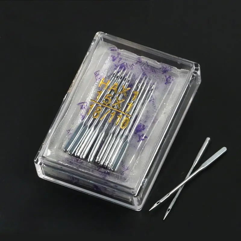A clear box containing a multi-pack of sewing machine needles with purple tint and gold markings.