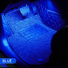 Blue ambient LED lighting illuminates the interior of a car, highlighting the dashboard and keyboard area.