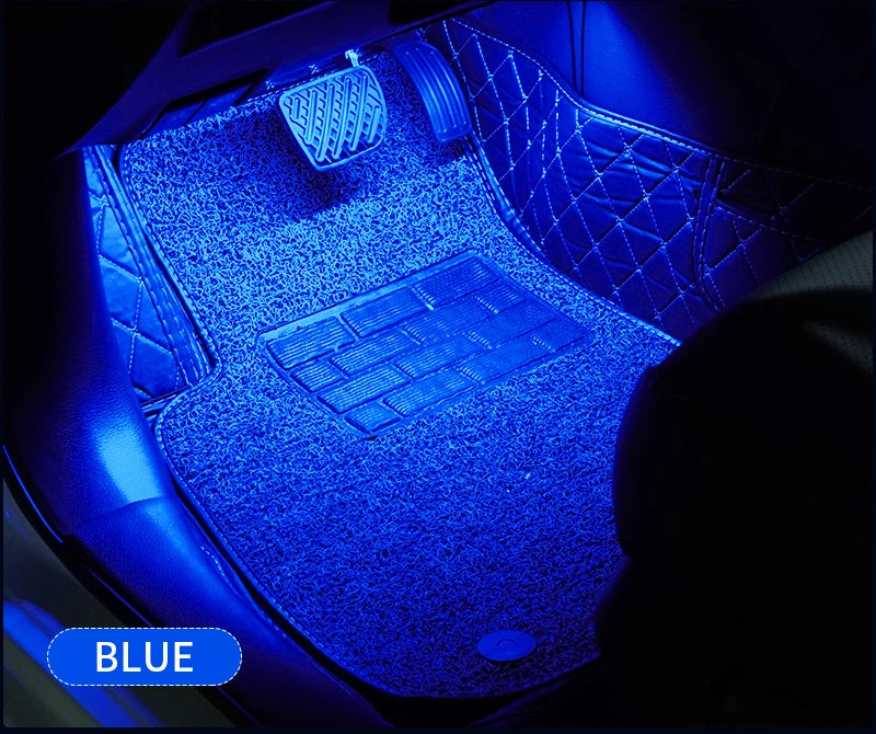 Blue ambient LED lighting illuminates the interior of a car, highlighting the dashboard and keyboard area.