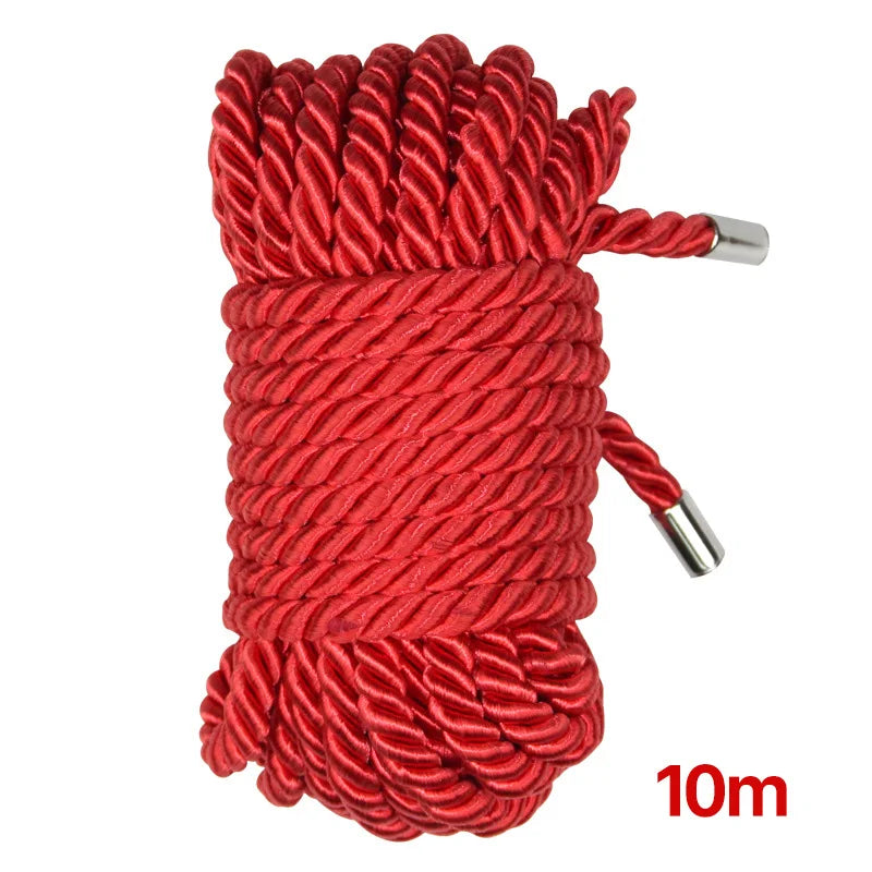 A spool of bright red soft silk bondage rope with silver tips, measuring 10 meters long.